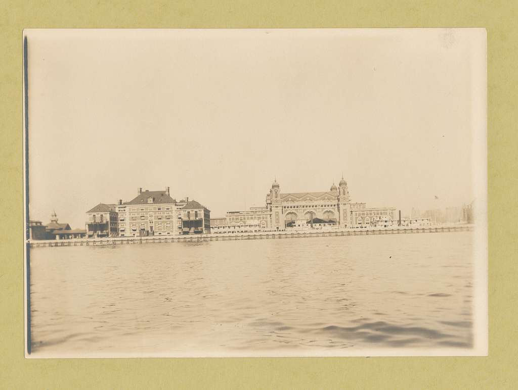 Immigrant Station, Ellis Island, with ferry docked at adjacent pier. - NYPL  Digital Collections